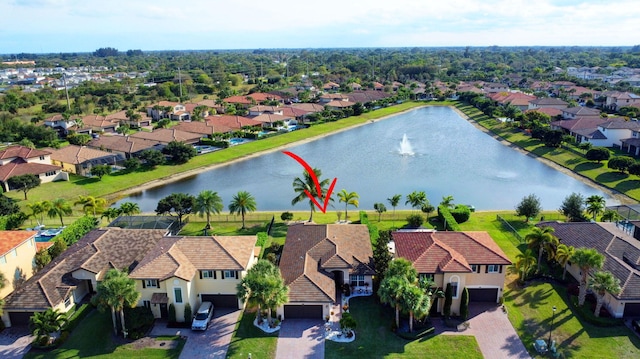 drone / aerial view with a water view and a residential view