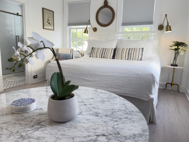 bedroom featuring baseboards and wood finished floors