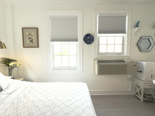 bedroom featuring baseboards and wood finished floors