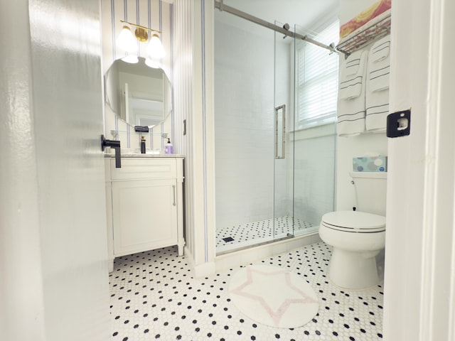 bathroom with toilet, a stall shower, tile patterned flooring, and vanity