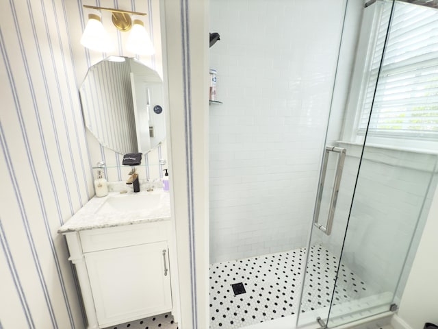 bathroom featuring a shower stall and vanity