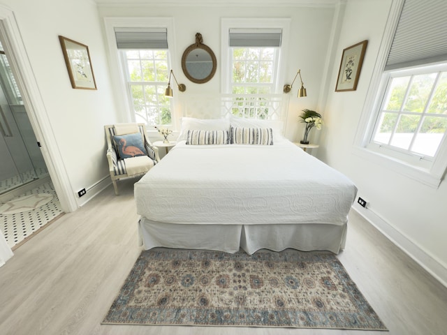 bedroom featuring wood finished floors and baseboards