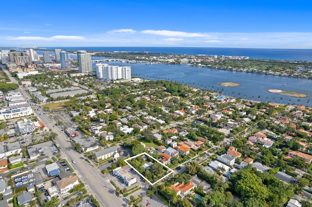 drone / aerial view featuring a water view and a view of city