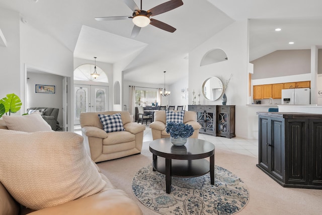 living room with french doors, recessed lighting, light carpet, high vaulted ceiling, and ceiling fan with notable chandelier