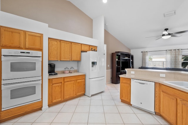 kitchen featuring white appliances, light countertops, vaulted ceiling, and visible vents