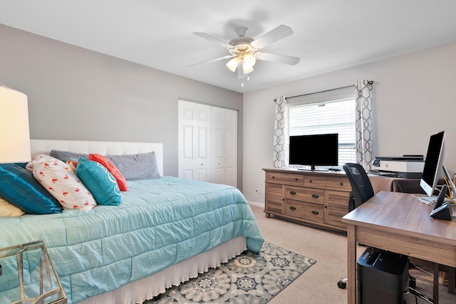 bedroom with ceiling fan, a closet, and light colored carpet