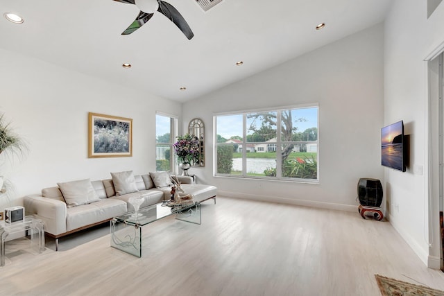 living area with lofted ceiling, recessed lighting, a ceiling fan, baseboards, and light wood-style floors