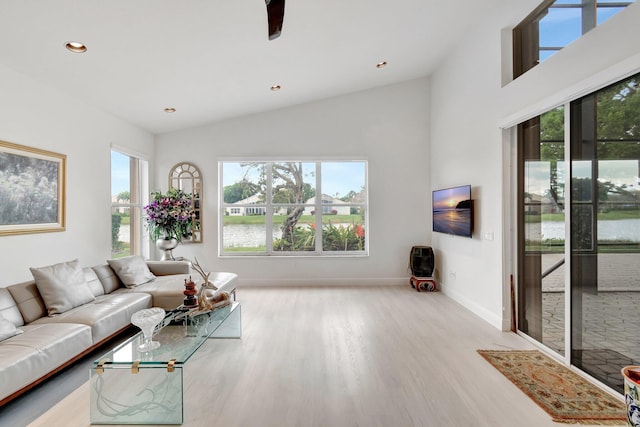 living room with vaulted ceiling, recessed lighting, light wood-style flooring, and baseboards