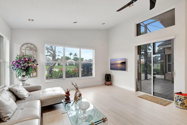 living room featuring recessed lighting, light wood-style flooring, and a healthy amount of sunlight