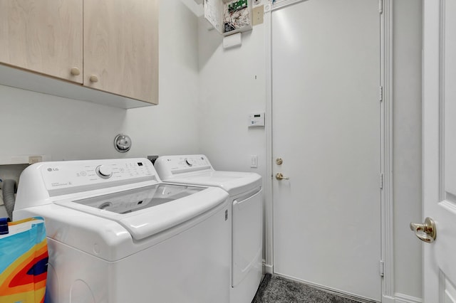 laundry area featuring washing machine and dryer and cabinet space