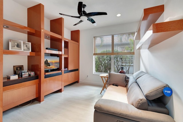 interior space with ceiling fan, baseboards, and light wood-style flooring