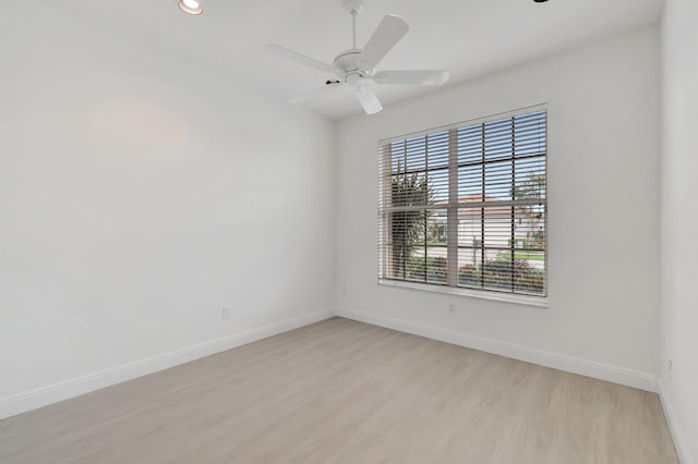 empty room with ceiling fan, baseboards, light wood-style flooring, and recessed lighting