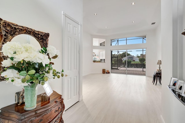 interior space featuring light wood finished floors, baseboards, and recessed lighting
