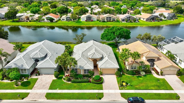 birds eye view of property featuring a water view and a residential view