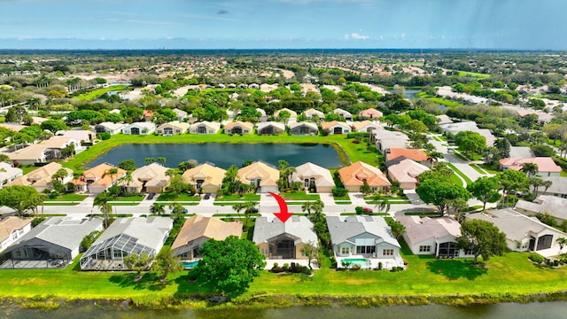 drone / aerial view with a water view and a residential view