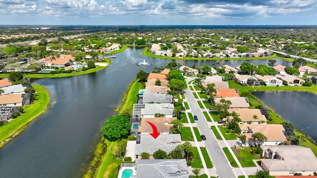 drone / aerial view featuring a residential view and a water view