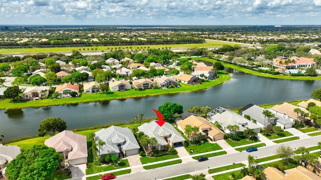 birds eye view of property featuring a water view and a residential view