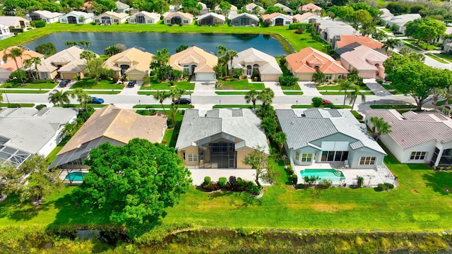 drone / aerial view featuring a water view and a residential view