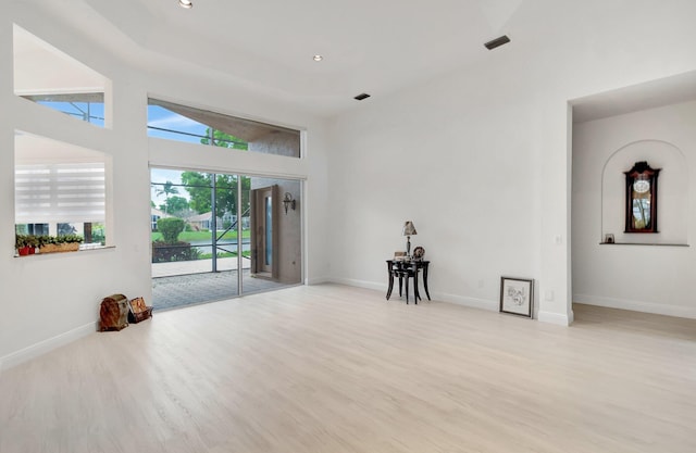spare room featuring recessed lighting, light wood-style flooring, and baseboards