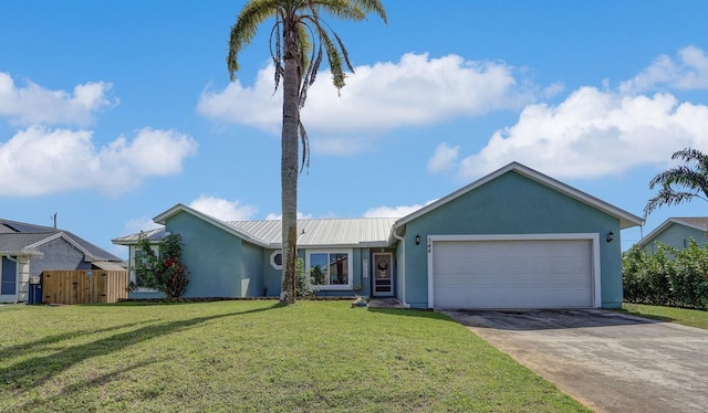 ranch-style home featuring stucco siding, concrete driveway, an attached garage, metal roof, and a front lawn