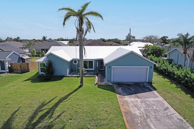 ranch-style house with a garage, concrete driveway, metal roof, a front lawn, and stucco siding