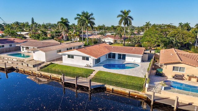 birds eye view of property with a water view and a residential view