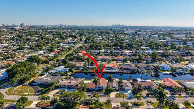 birds eye view of property with a water view and a residential view