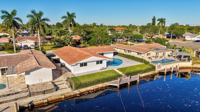 birds eye view of property featuring a water view and a residential view