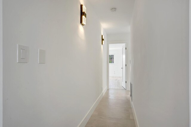 hallway featuring baseboards