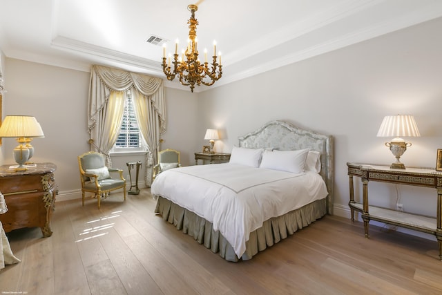 bedroom featuring crown molding, visible vents, a chandelier, light wood-type flooring, and baseboards