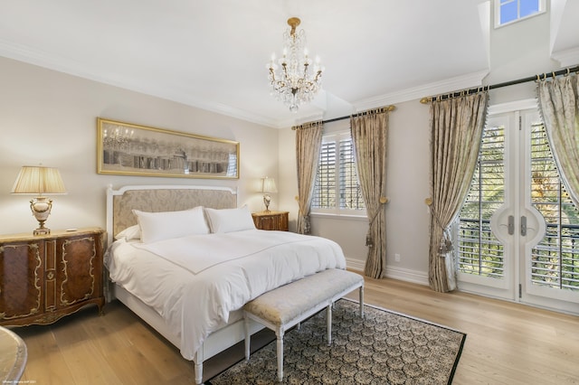 bedroom with ornamental molding, light wood-style flooring, baseboards, and an inviting chandelier