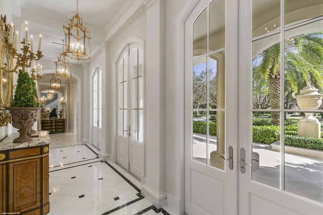 doorway to outside featuring ornamental molding, french doors, plenty of natural light, and a chandelier