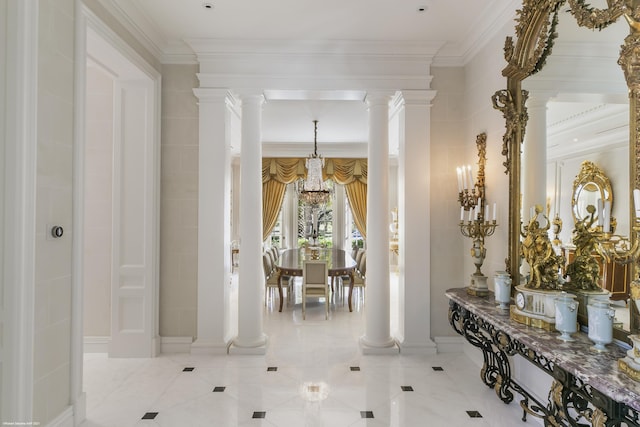 interior space featuring crown molding, tile patterned flooring, a notable chandelier, and ornate columns