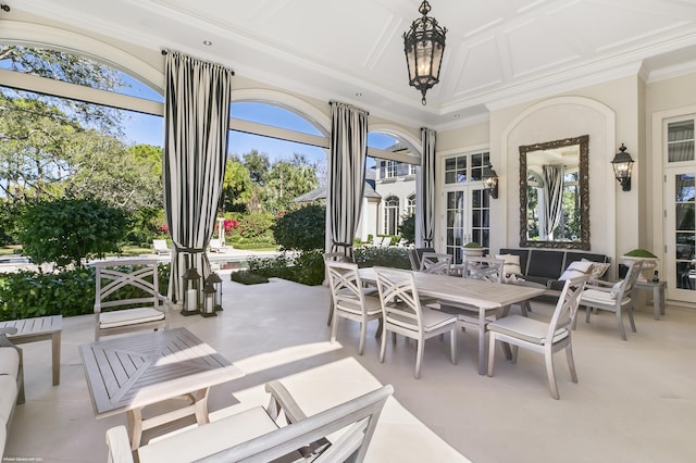 sunroom with an inviting chandelier, coffered ceiling, and a wealth of natural light