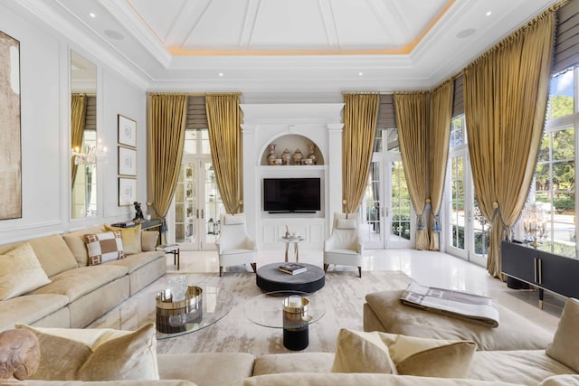 living room with ornamental molding, french doors, a towering ceiling, and built in shelves