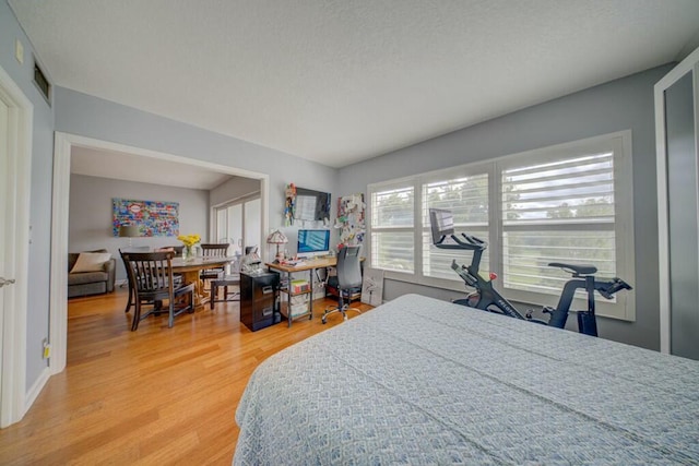 bedroom featuring wood finished floors and baseboards