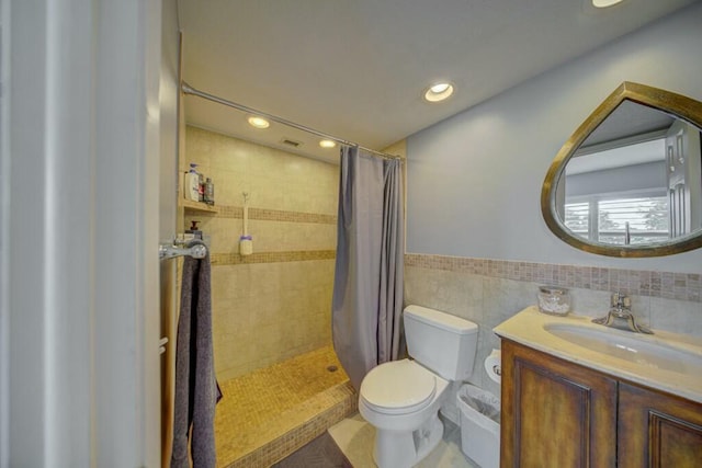 full bathroom featuring toilet, vanity, a shower stall, tile walls, and recessed lighting