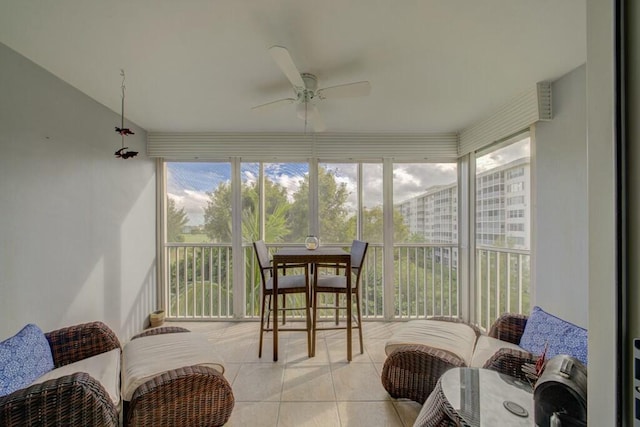 sunroom featuring a ceiling fan