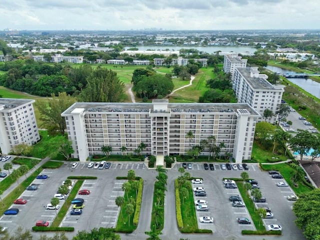 birds eye view of property featuring a water view and a view of city