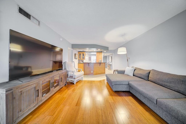 living area featuring visible vents and light wood-style flooring