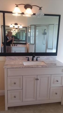 full bath featuring a shower stall and vanity