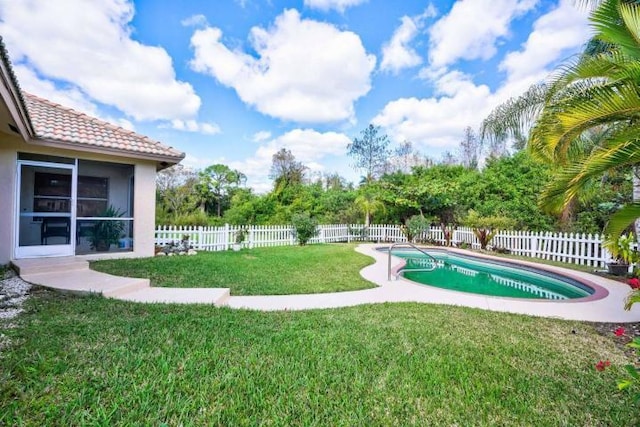 view of swimming pool with a fenced in pool, a fenced backyard, and a lawn