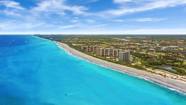 birds eye view of property featuring a water view and a beach view