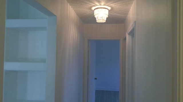 hallway featuring a notable chandelier