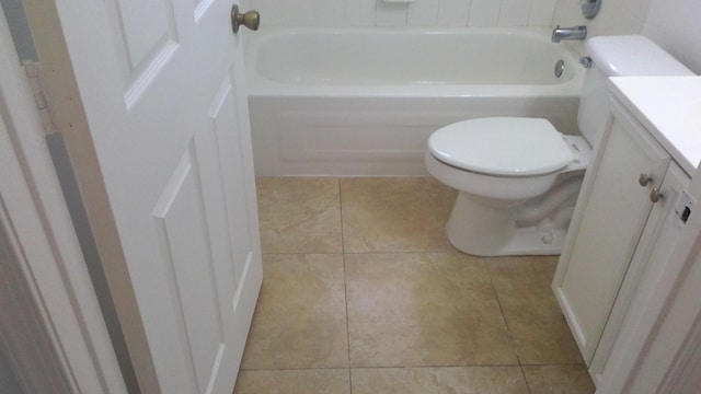 full bathroom with toilet, tile patterned floors, a tub to relax in, and vanity