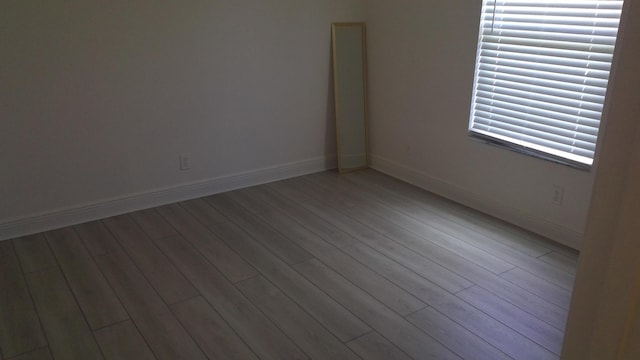 empty room featuring light wood-style flooring and baseboards