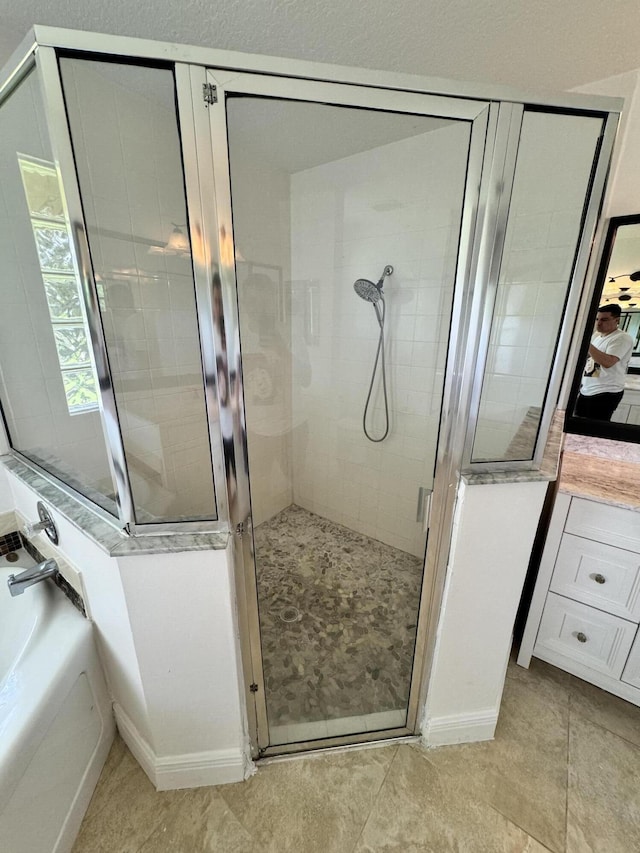 full bathroom featuring a garden tub, a shower stall, and tile patterned flooring