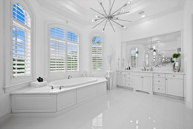 bathroom with a garden tub, an inviting chandelier, ornamental molding, and a healthy amount of sunlight