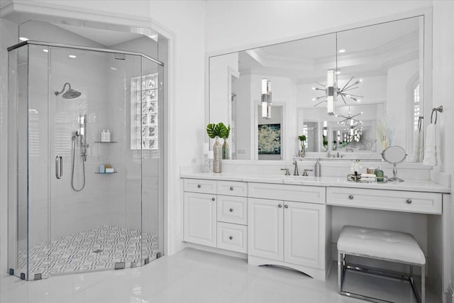 full bath featuring a shower stall, ornamental molding, a chandelier, and vanity