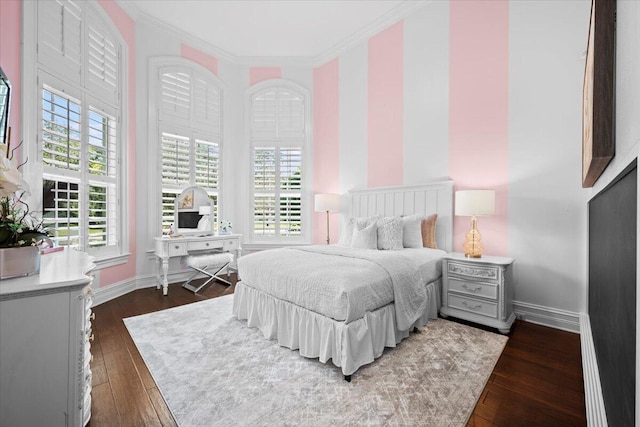 bedroom featuring dark wood-style floors, ornamental molding, and baseboards